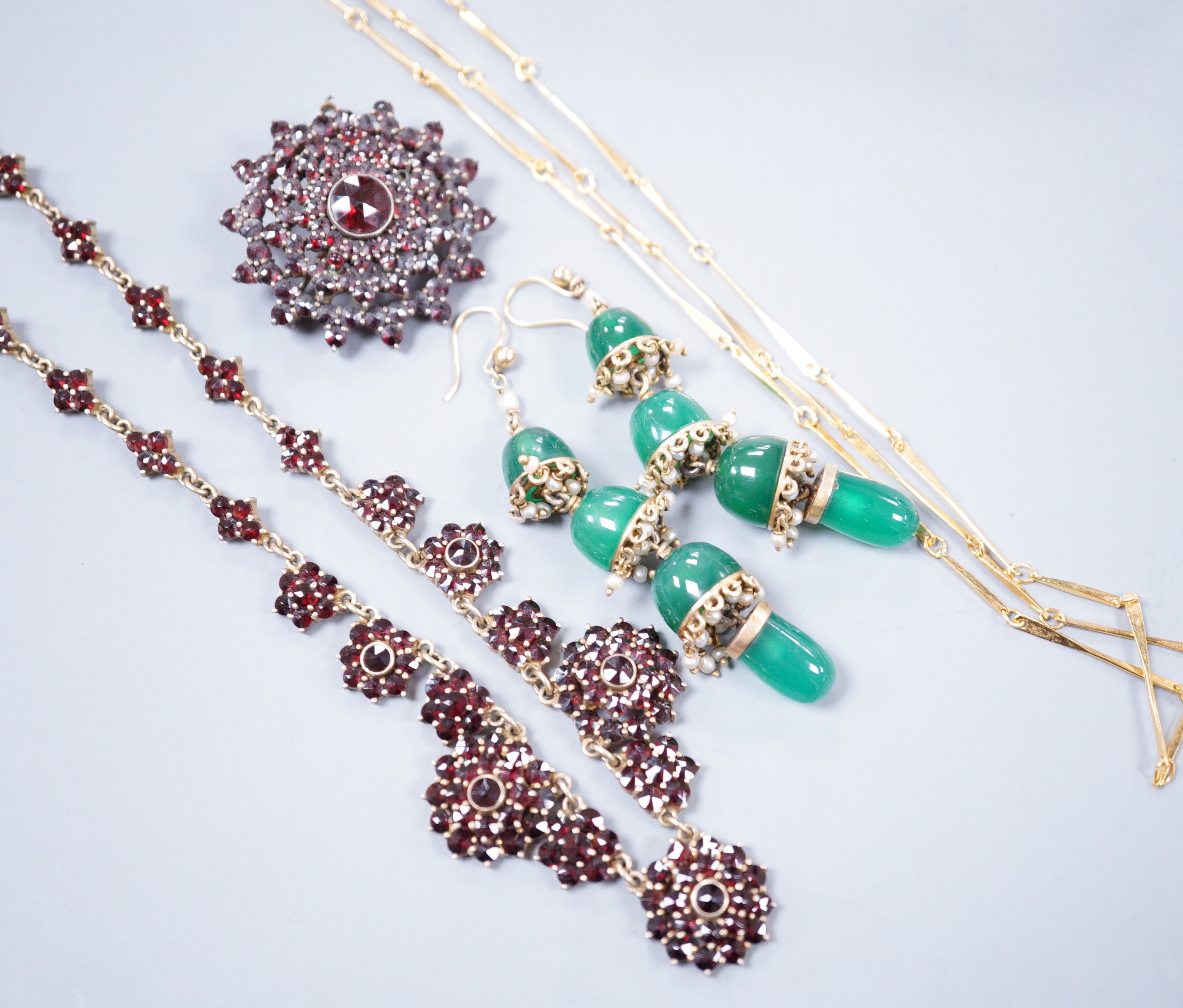 A Victorian gilt white metal and facetted garnet cluster set necklace, 42cm, a similar brooch, a pair of chrysoprase set drop earrings and a gilt metal necklace.